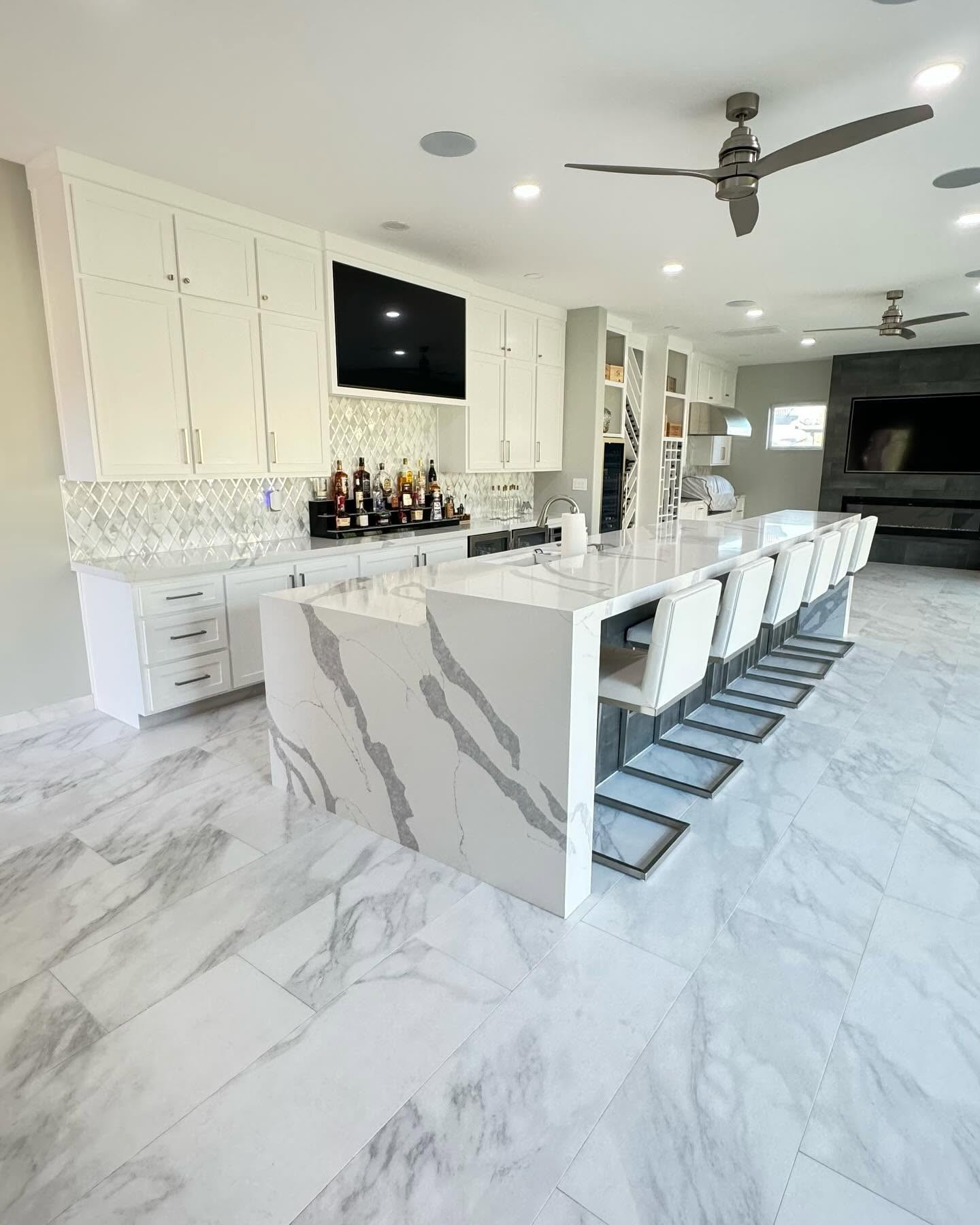 Marble waterfall bar and full stone kitchen installed by Creative Stone